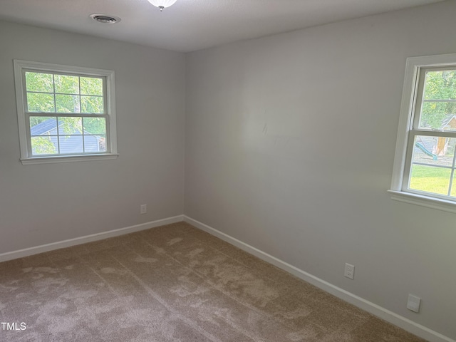 5026 Gatewood Dr, Durham, NC 27712 - carpeted spare room with a wealth of natural light, baseboards, and visible vents