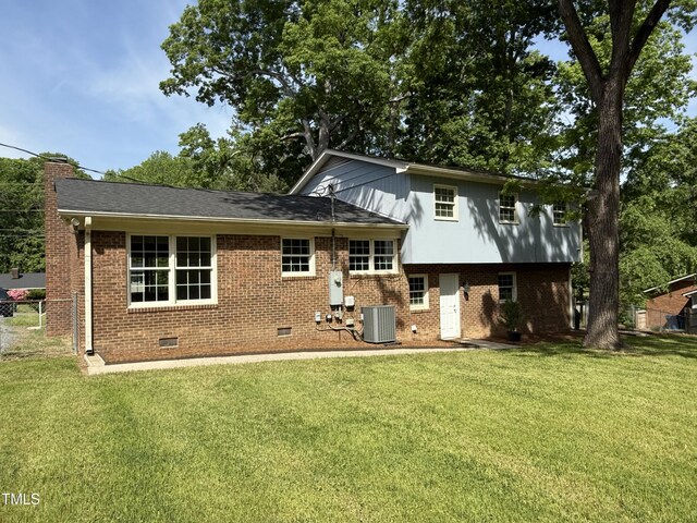 5026 Gatewood Dr, Durham, NC 27712 - rear view of property featuring crawl space, a lawn, brick siding, and central air condition unit