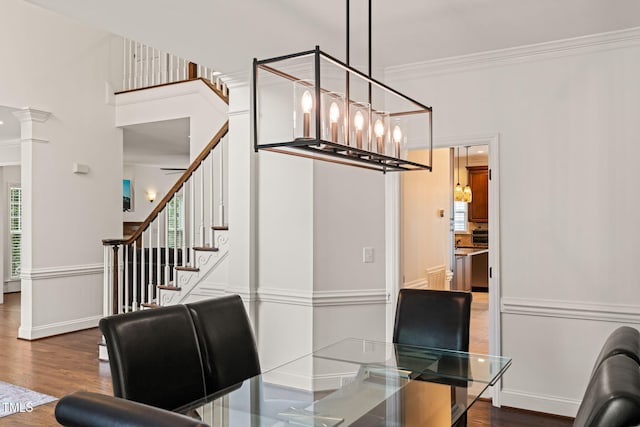 2000 Katesbridge Ln, Raleigh, NC 27614 - dining space featuring wood finished floors, ornamental molding, stairs, a chandelier, and decorative columns