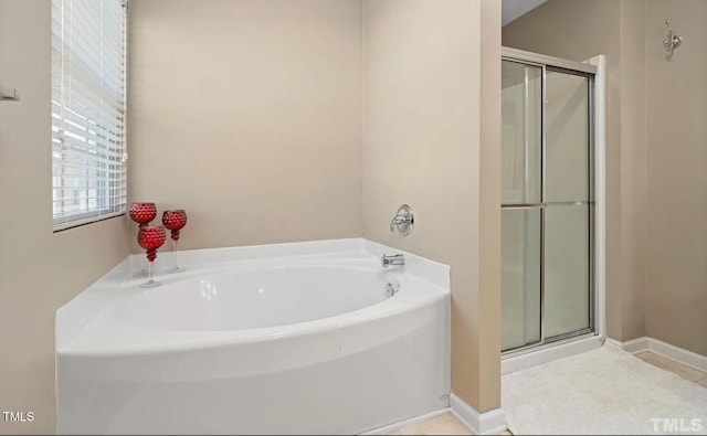 bathroom with a bath and a shower stall