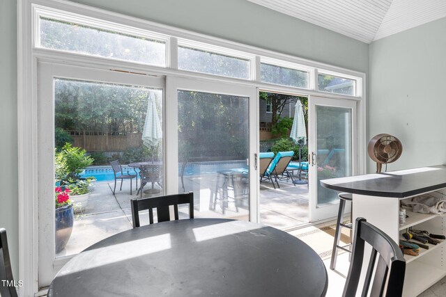 dining room featuring lofted ceiling and a wealth of natural light