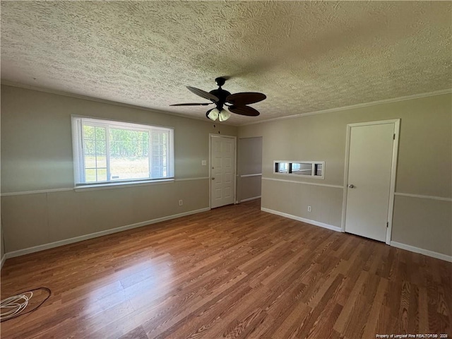 unfurnished bedroom featuring crown molding, wood finished floors, and a textured ceiling