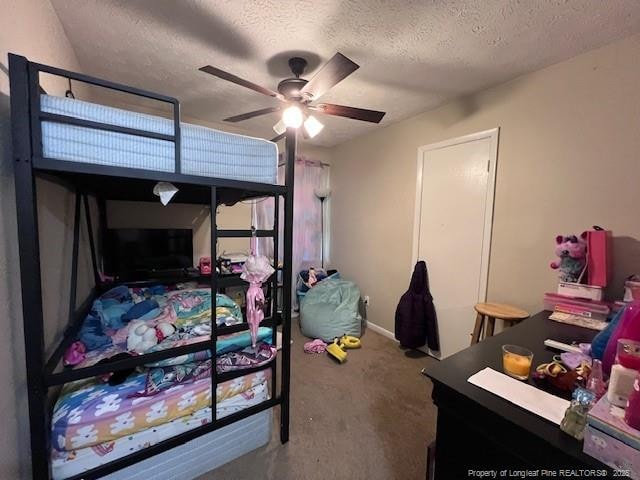 bedroom featuring carpet flooring, a textured ceiling, and ceiling fan