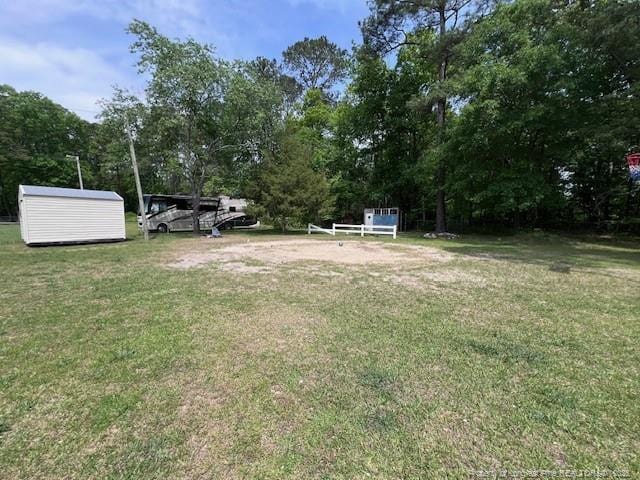 view of yard with an outbuilding and a storage shed