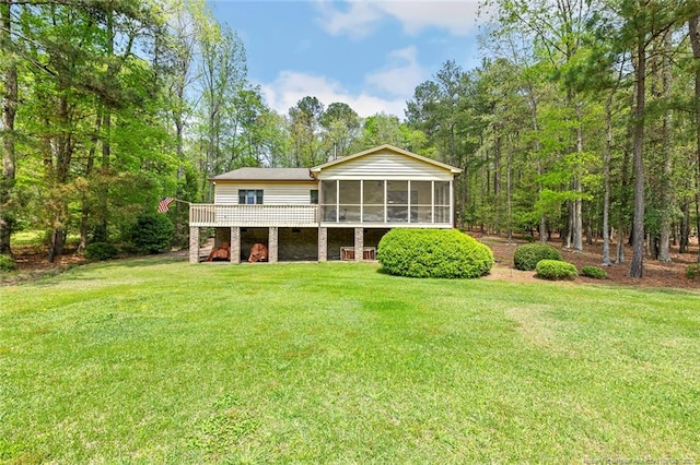 1619 Stonegate N, Sanford, NC 27332 - rear view of house with a wooden deck, a sunroom, and a yard