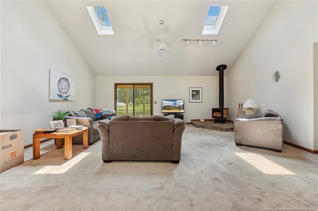 1619 Stonegate N, Sanford, NC 27332 - living area with carpet floors, a wood stove, a skylight, and high vaulted ceiling