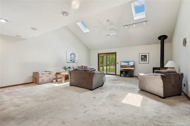 1619 Stonegate N, Sanford, NC 27332 - living area with carpet, a wood stove, a ceiling fan, a skylight, and baseboards