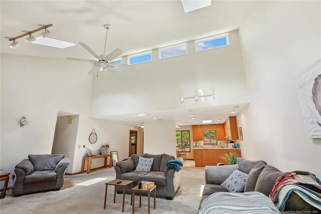 1619 Stonegate N, Sanford, NC 27332 - living area with ceiling fan, a high ceiling, rail lighting, and light carpet