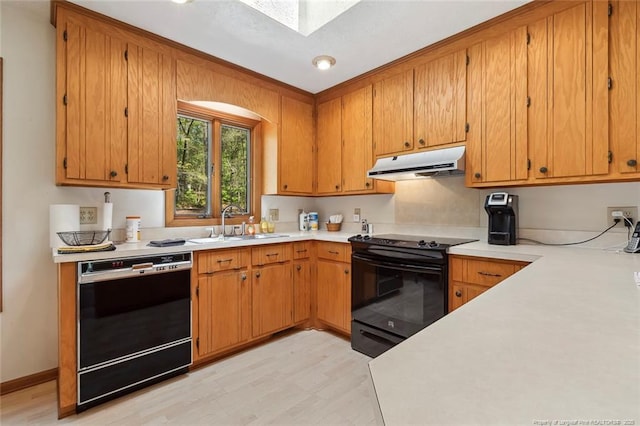 1619 Stonegate N, Sanford, NC 27332 - kitchen with a sink, light wood-style floors, light countertops, under cabinet range hood, and black appliances