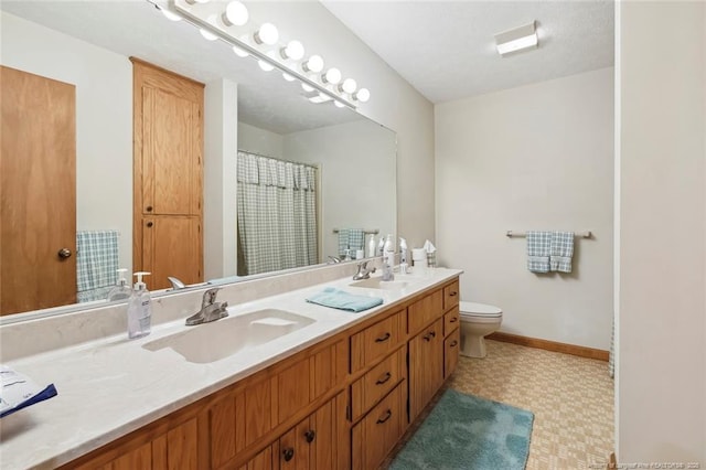 1619 Stonegate N, Sanford, NC 27332 - full bath featuring tile patterned floors, a sink, double vanity, and toilet