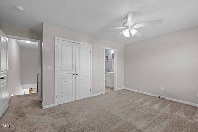unfurnished bedroom with carpet floors, a closet, and baseboards