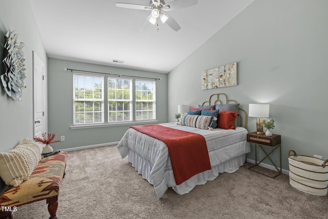 carpeted bedroom with vaulted ceiling, baseboards, and ceiling fan