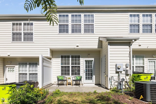 rear view of house featuring cooling unit and a patio area