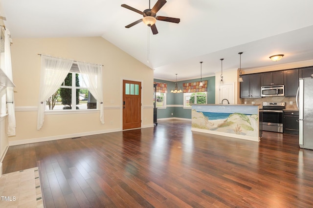 71 Potted Plant Ct, Clayton, NC 27520 - unfurnished living room featuring baseboards, lofted ceiling, ceiling fan with notable chandelier, and dark wood-type flooring