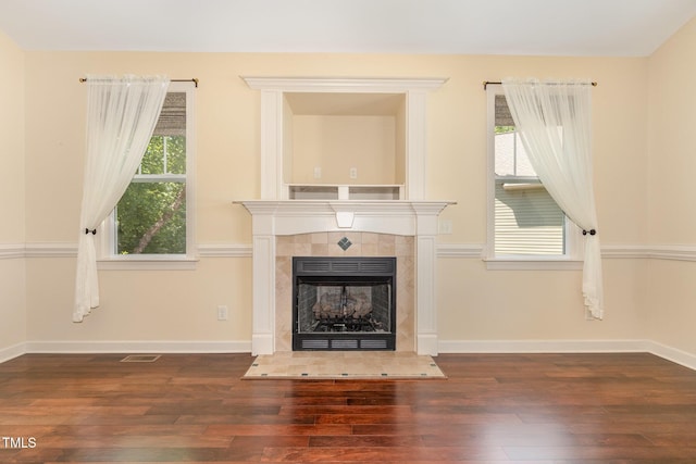 71 Potted Plant Ct, Clayton, NC 27520 - unfurnished living room with visible vents, baseboards, wood finished floors, and a tile fireplace