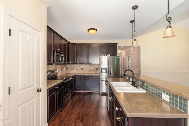 71 Potted Plant Ct, Clayton, NC 27520 - kitchen with dark wood-style flooring, dark brown cabinetry, a sink, stainless steel appliances, and decorative backsplash