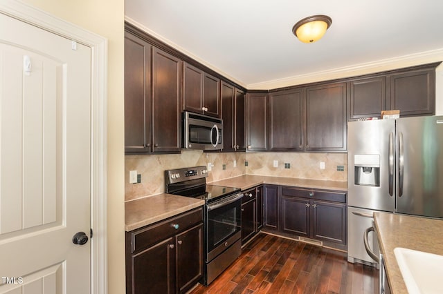 71 Potted Plant Ct, Clayton, NC 27520 - kitchen featuring dark brown cabinets, appliances with stainless steel finishes, light countertops, dark wood-type flooring, and backsplash
