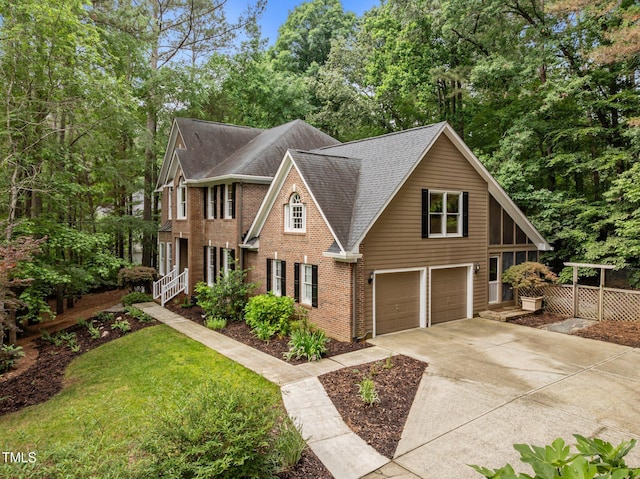view of front of property featuring roof with shingles, an attached garage, concrete driveway, brick siding, and view of scattered trees