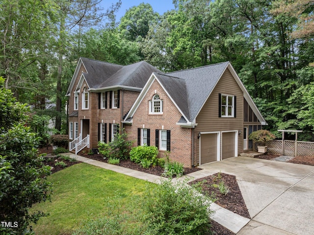 view of front of home with an attached garage, driveway, roof with shingles, and brick siding