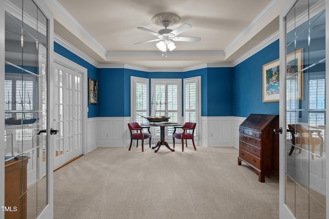 home office with french doors, a wainscoted wall, a decorative wall, crown molding, and carpet