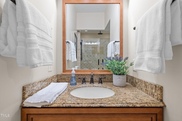 full bath featuring a stall shower and vanity
