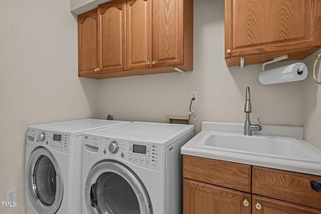 laundry room with washing machine and dryer and cabinet space