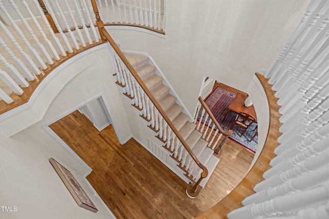 stairway featuring wood finished floors and baseboards