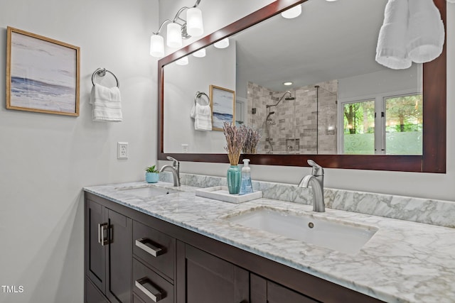 bathroom with a stall shower and double vanity