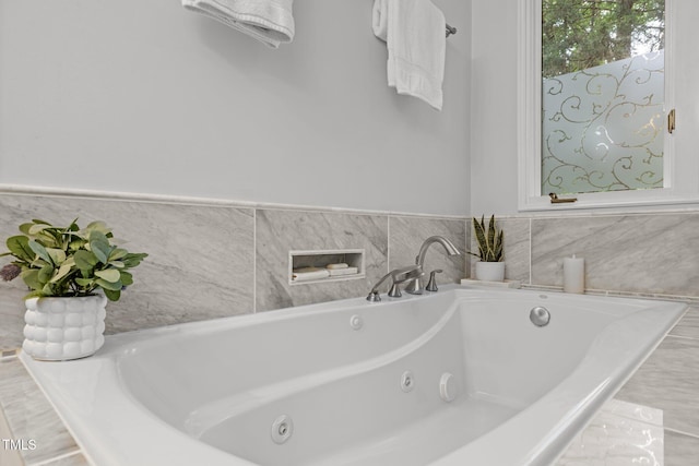 full bathroom with a tub with jets