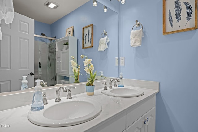 bathroom with a stall shower and double vanity