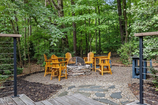 wooden deck featuring an outdoor fire pit