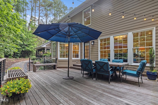 deck with outdoor dining area