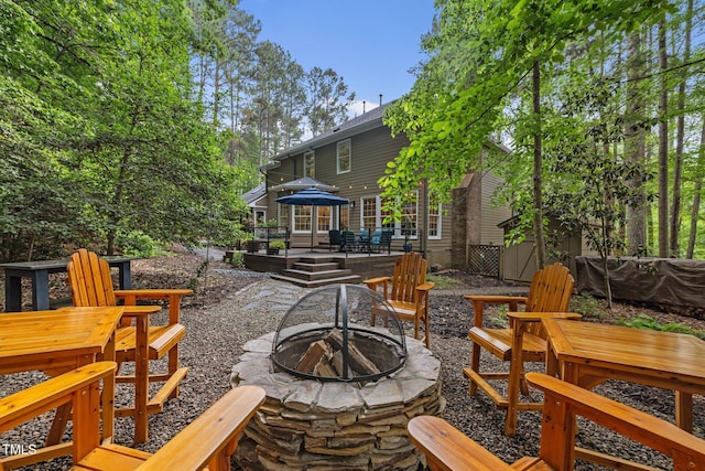 view of patio featuring a fire pit and a wooden deck