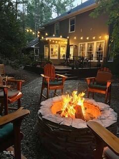 back of house featuring an outdoor fire pit