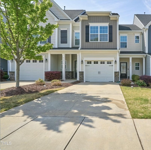 225 Gulley Glen Dr, Garner, NC 27529 - view of front of property featuring a porch, board and batten siding, stone siding, concrete driveway, and an attached garage