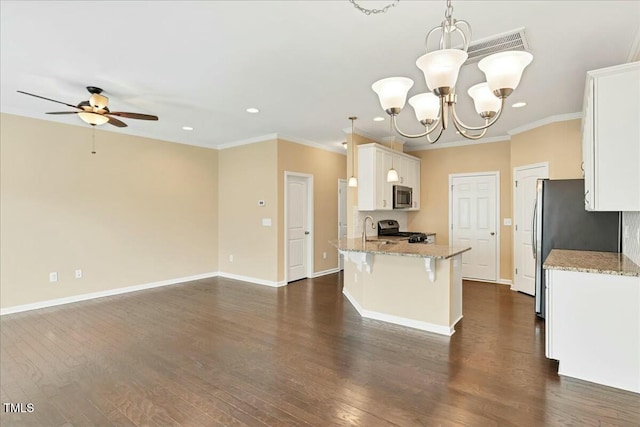 225 Gulley Glen Dr, Garner, NC 27529 - kitchen with stainless steel appliances, crown molding, light stone counters, white cabinetry, and ceiling fan with notable chandelier