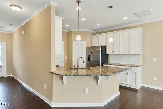225 Gulley Glen Dr, Garner, NC 27529 - kitchen featuring stainless steel fridge, a sink, visible vents, a kitchen breakfast bar, and dark wood-type flooring