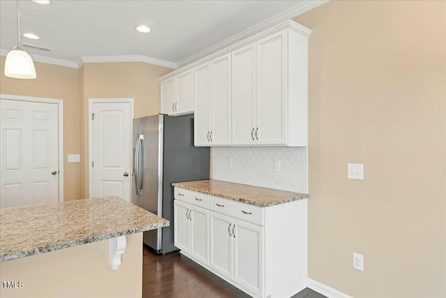 225 Gulley Glen Dr, Garner, NC 27529 - kitchen featuring crown molding, white cabinets, freestanding refrigerator, and backsplash