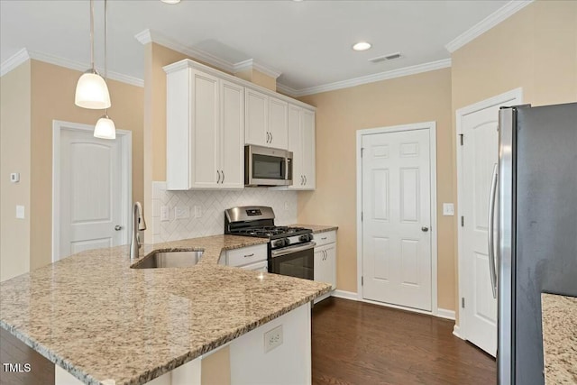 225 Gulley Glen Dr, Garner, NC 27529 - kitchen with appliances with stainless steel finishes, a sink, white cabinetry, visible vents, and a peninsula