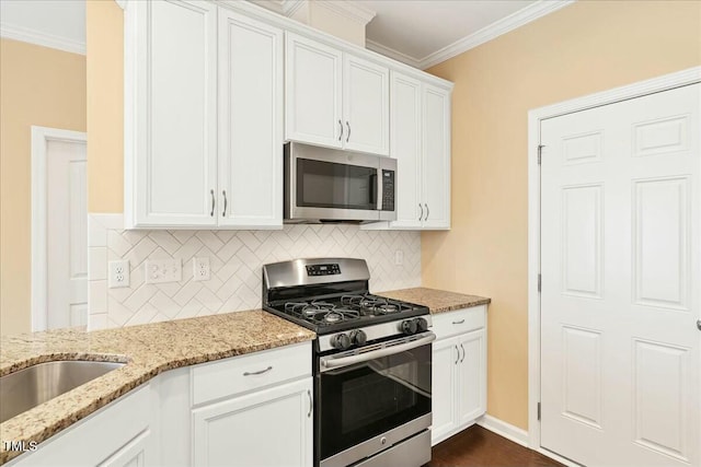 225 Gulley Glen Dr, Garner, NC 27529 - kitchen featuring appliances with stainless steel finishes, crown molding, white cabinets, and backsplash