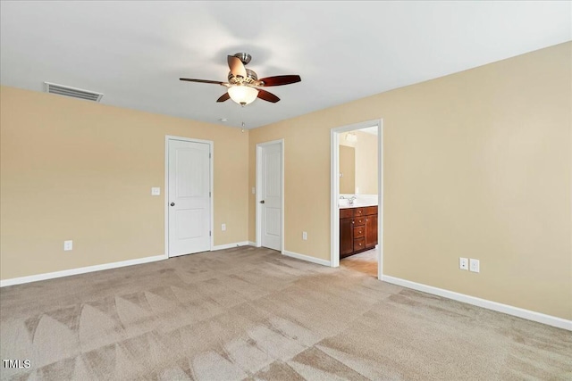 225 Gulley Glen Dr, Garner, NC 27529 - unfurnished bedroom featuring visible vents, ensuite bathroom, light carpet, and baseboards