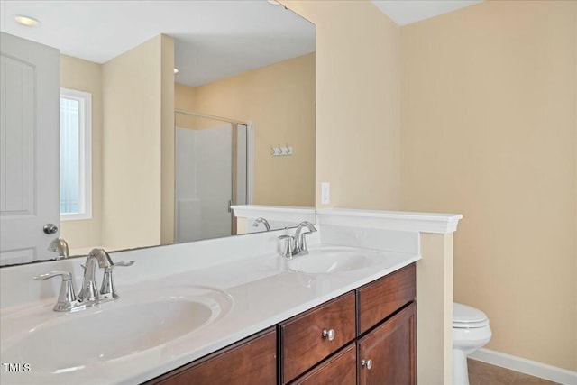 225 Gulley Glen Dr, Garner, NC 27529 - bathroom featuring a shower stall, toilet, tile patterned flooring, and a sink