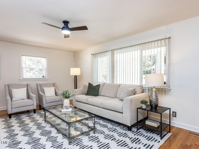3818 Hillgrand Dr, Durham, NC 27705 - living area featuring baseboards, wood finished floors, visible vents, and a ceiling fan