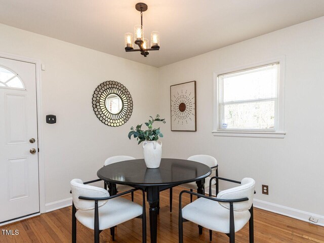 3818 Hillgrand Dr, Durham, NC 27705 - dining area with baseboards, a notable chandelier, and wood finished floors