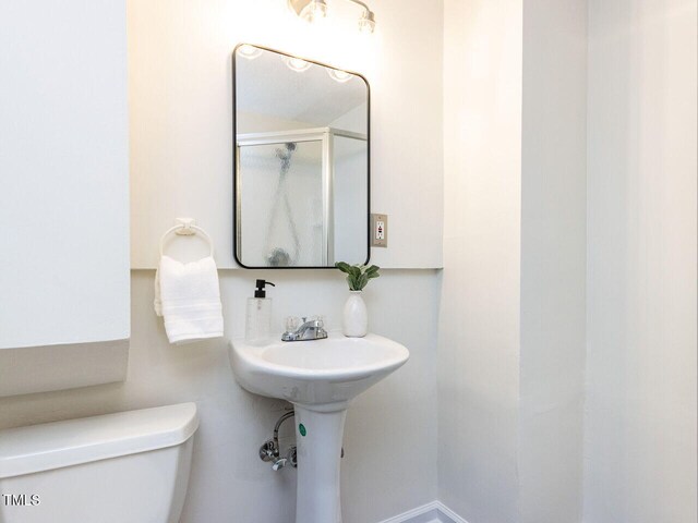 3818 Hillgrand Dr, Durham, NC 27705 - bathroom featuring a shower with door and toilet