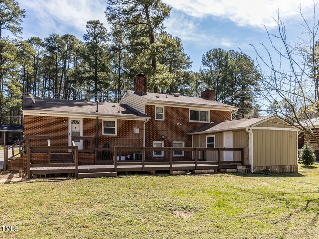3818 Hillgrand Dr, Durham, NC 27705 - back of house featuring brick siding, a yard, a chimney, and a deck