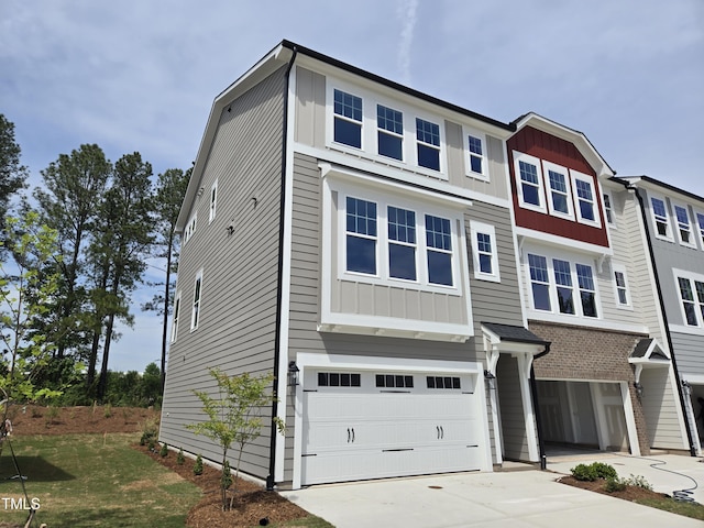 multi unit property featuring board and batten siding, driveway, and a garage