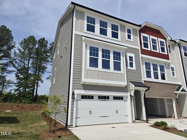 townhome / multi-family property featuring concrete driveway, an attached garage, and board and batten siding