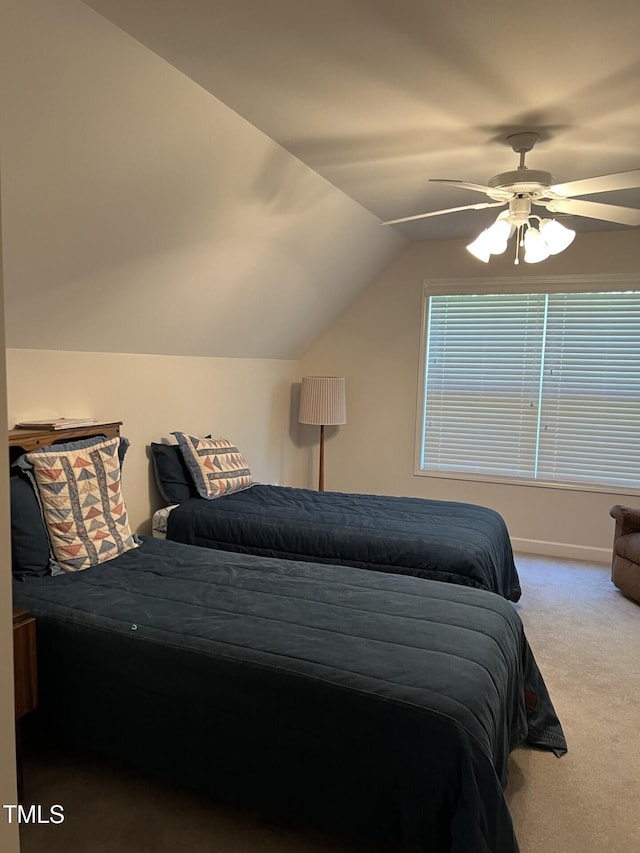 bedroom with ceiling fan, lofted ceiling, and carpet flooring