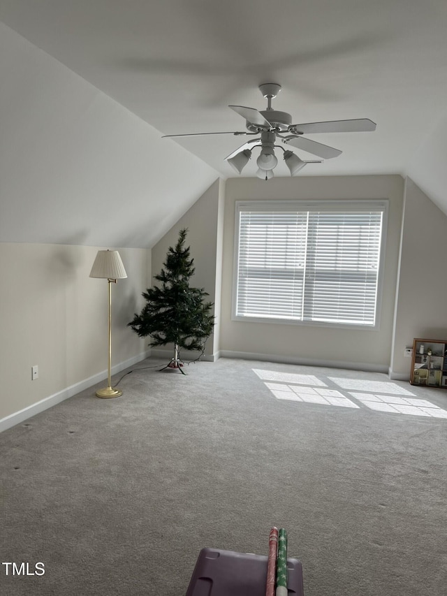 additional living space featuring carpet flooring, ceiling fan, lofted ceiling, and baseboards